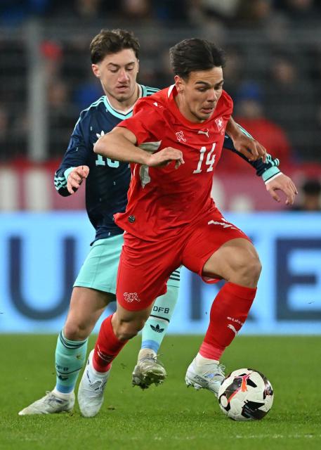 Germany's midfielder Angelo Stiller fights for the ball with Switzerland’s midfielder #14 Ardon Jashari during the international friendly football match between Switzerland and Germany at St. Jakob-Park in Basel, Switzerland on March 27, 2026. (Photo by Fabrice COFFRINI / AFP)