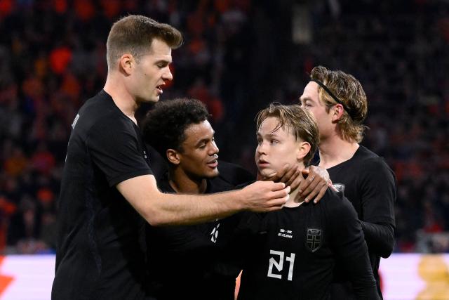 Norway's defender #21 Andreas Schjolberg (2R) celebrates with teammates Norway's forward #07 Alexander Sorloth (L) amd Norway's midfielder #22 Oscar Bobb after scoring his team's first goal during a friendly football match between the Netherlands and Norway at the Johan Cruijff Arena in Amsterdam on March 27, 2026. (Photo by JOHN THYS / AFP)