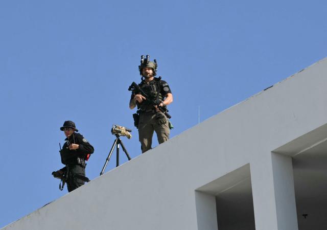 US Secret Service counter-sniper agents stand guard on the roof of the hotel where President Donald Trump will address the Future Investment Initiative (FII) Summit in Miami Beach, Florida, on March 27, 2026. (Photo by Mandel NGAN / AFP)