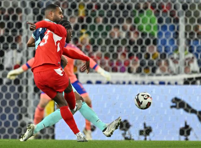 Switzerland’s forward #25 Joel Monteiro (L) shoots to score his team's third goal during the international friendly football match between Switzerland and Germany at St. Jakob-Park in Basel, Switzerland on March 27, 2026. (Photo by Fabrice COFFRINI / AFP)