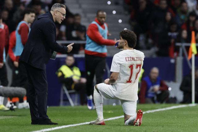 Morocco's  head coach #00 Mohamed Ouahbi speaks with Morocco's  forward #17 Abde Ezzalzouli during the international friendly football match between Morocco and Ecuador at Metropolitano Stadium in Madrid on March 27, 2026. (Photo by Oscar DEL POZO / AFP)