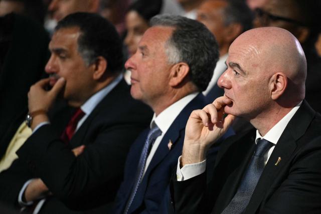 FIFA President Gianni Infantino (R) and the US Special Envoy to the Middle East Steve Witkoff (C) listen to US President Donald Trump address at the Future Investment Initiative (FII) Summit in Miami Beach, Florida, on March 27, 2026. (Photo by Mandel NGAN / AFP)