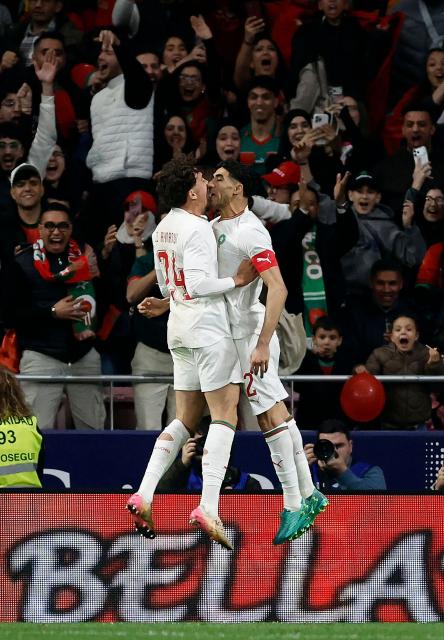 TOPSHOT - Morocco's  midfielder #24 Neil El Aynaoui (L) celebrates scoring an equalizing goal with Morocco's defender #02 Achraf Hakimi during the international friendly football match between Morocco and Ecuador at Metropolitano Stadium in Madrid on March 27, 2026. (Photo by Oscar DEL POZO / AFP)