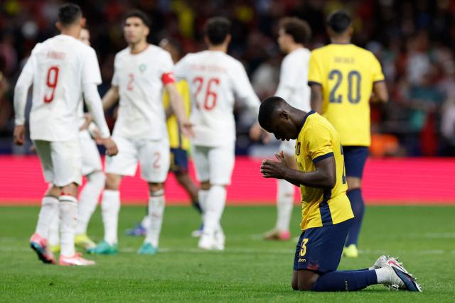 Ecuador's  midfielder #23 Moises Caicedo kneels at the end of the international friendly football match between Morocco and Ecuador at Metropolitano Stadium in Madrid on March 27, 2026. (Photo by Oscar DEL POZO / AFP)