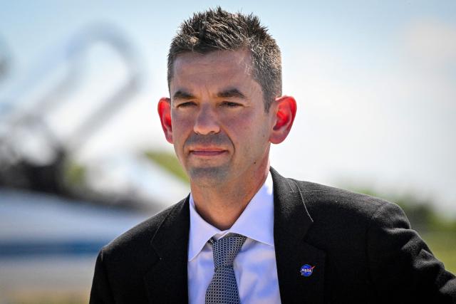NASA Administrator Jared Isaacman attends a welcome ceremony for the Artemis II mission crew members ahead of the April 1 launch at Kennedy Space Center in Florida on March 27, 2026. NASA and Canadian Space Agency astronauts assigned to the Artemis II mission arrive at Kennedy Space Center in Florida on March 27, 2026, to begin final pre-launch preparations for the first crewed lunar flyby in the Artemis program. The journey, set to last around 10 days, will take the astronauts on a loop around the Moon, though they will not land on its surface. The crew comprises the first woman, the first person of color and the first non-American to take part in such a journey. (Photo by Miguel J Rodriguez Carrillo / AFP)