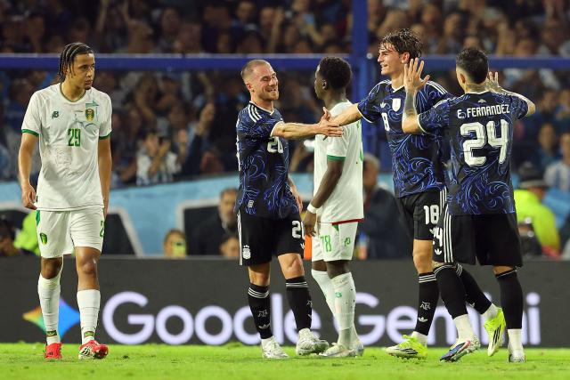 Argentina's midfielder #18 Nico Paz (2nd R) celebrates with teammates midfielder #20 Alexis Mac Allister and midfielder #24 Enzo Fernandez after scoring his team's second goal during a friendly football match between Argentina and Mauritania at La Bombonera stadium in Buenos Aires on March 27, 2026. (Photo by ALEJANDRO PAGNI / AFP)