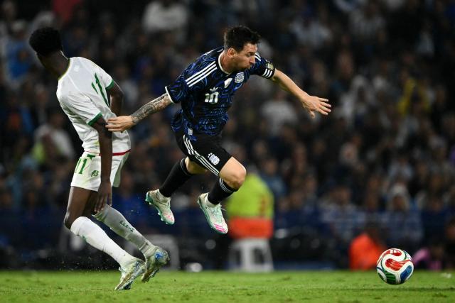 Mauritania's midfielder #11 Maata Magassa and Argentina's forward #10 Lionel Messi fight for the ball during a friendly football match between Argentina and Mauritania at the La Bombonera Stadium in Buenos Aires on March 27, 2026. (Photo by Luis ROBAYO / AFP)