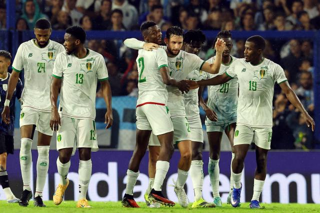 Mauritania's defender #21 Jordan Lefort (C, right) celebrates with teammates after scoring a goal during a friendly football match between Argentina and Mauritania at La Bombonera stadium in Buenos Aires on March 27, 2026. (Photo by ALEJANDRO PAGNI / AFP)