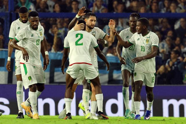 Mauritania's defender #21 Jordan Lefort (C) celebrates with teammates after scoring a goal during a friendly football match between Argentina and Mauritania at La Bombonera stadium in Buenos Aires on March 27, 2026. (Photo by ALEJANDRO PAGNI / AFP)