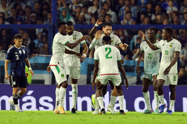 Mauritania's defender #21 Jordan Lefort (C) celebrates with teammates after scoring a goal during a friendly football match between Argentina and Mauritania at La Bombonera stadium in Buenos Aires on March 27, 2026. (Photo by ALEJANDRO PAGNI / AFP)
