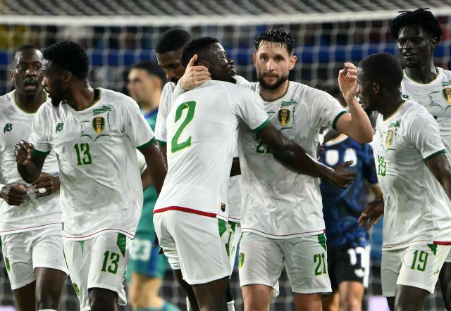 Mauritania's defender #21 Jordan Lefort celebrates with teammates after scoring his team's first goal during a friendly football match between Argentina and Mauritania at the La Bombonera Stadium in Buenos Aires on March 27, 2026. (Photo by Luis ROBAYO / AFP)