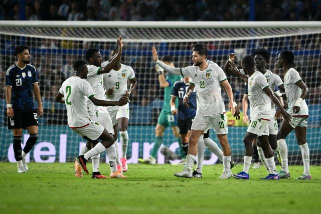 Mauritania's defender #21 Jordan Lefort (C) celebrates with teammates after scoring a goal during a friendly football match between Argentina and Mauritania at La Bombonera stadium in Buenos Aires on March 27, 2026. (Photo by Luis ROBAYO / AFP)