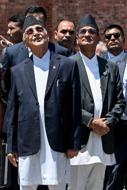 (FILES) Nepal's Prime Minister KP Sharma Oli (front L) and Home Minister Ramesh Lekhak (front R) arrive to pay homage to victims of the 2015 earthquake on its 10th anniversary in Kathmandu on April 25, 2025. Nepal's former prime minister KP Sharma Oli and ex-home minister Ramesh Lekhak were arrested early on March 28, 2026 over their alleged involvement in a deadly crackdown on protestors in September, police said. (Photo by PRAKASH MATHEMA / AFP)