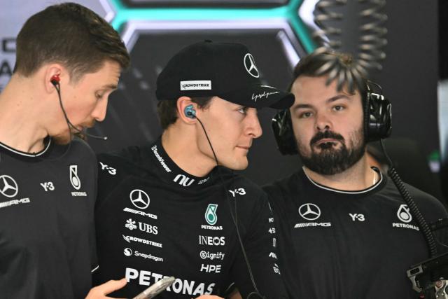 Mercedes' British driver George Russell (C) looks on from the pit before the start of the third practice session ahead of the Formula One Japanese Grand Prix at the Suzuka circuit in Suzuka, Mie prefecture on March 28, 2026. (Photo by Toshifumi KITAMURA / AFP)