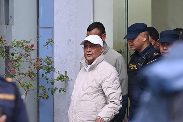 Nepal's former prime minister KP Sharma Oli (C) is escorted by police as he is brought to the hospital from the Kathmandu district police office following his arrest on March 28, 2026. Nepal's former prime minister KP Sharma Oli and ex-home minister Ramesh Lekhak were arrested March 28 over their alleged involvement in a deadly crackdown on protestors in September, police said. (Photo by Prakash Mathema / AFP)
