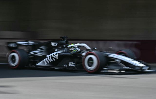 Sparks fly as Cadillac's Mexican driver Sergio Perez drives during the third practice session ahead of the Formula One Japanese Grand Prix at the Suzuka circuit in Suzuka, Mie prefecture on March 28, 2026. (Photo by Philip FONG / AFP)