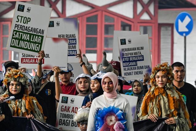 Environmental activists take part in a procession ahead of Earth Hour in Banda Aceh on March 28, 2026. (Photo by CHAIDEER MAHYUDDIN / AFP)