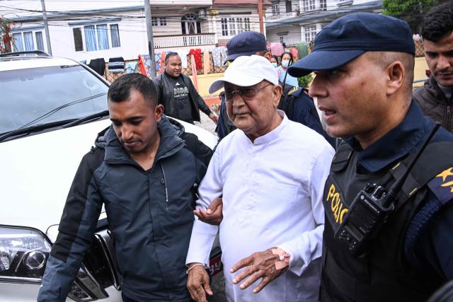 Nepal's former prime minister KP Sharma Oli (C) is escorted by police as he is brought to the hospital following his arrest in Kathmandu on March 28, 2026. Nepal's former prime minister KP Sharma Oli and ex-home minister Ramesh Lekhak were arrested March 28 over their alleged involvement in a deadly crackdown on protestors in September, police said. (Photo by PRAKASH MATHEMA / AFP)