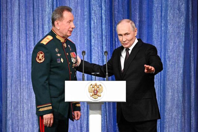 In this pool photograph distributed by the Russian state agency Sputnik, Russian President Vladimir Putin talk to the Director of the Federal Service of National Guard Troops - Commander-in-Chief of the National Guard Troops of the Russian Federation (Rosgvardia) Viktor Zolotov (L) during a gala evening in the State Kremlin Palace in Moscow dedicated to the 10th anniversary of the Rosgvardia, on March 27, 2026. (Photo by Sergei BOBYLYOV / POOL / AFP)
