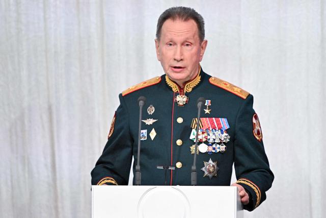 In this pool photograph distributed by the Russian state agency Sputnik, the Director of the Federal Service of National Guard Troops - Commander-in-Chief of the National Guard Troops of the Russian Federation (Rosgvardia) Viktor Zolotov (L) speaks during a gala evening in the State Kremlin Palace in Moscow dedicated to the 10th anniversary of the Rosgvardia, on March 27, 2026. (Photo by Sergei BOBYLYOV / POOL / AFP)