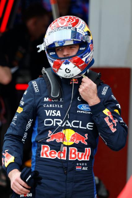 Red Bull Racing's Dutch driver Max Verstappen takes off his helmet in the pits during the qualifying session ahead of the Formula One Japanese Grand Prix at the Suzuka circuit in Suzuka, Mie prefecture on March 28, 2026. (Photo by FRANCK ROBICHON / POOL / AFP)