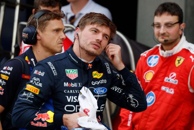 Red Bull Racing's Dutch driver Max Verstappen takes off his earpiece in the pits during the qualifying session ahead of the Formula One Japanese Grand Prix at the Suzuka circuit in Suzuka, Mie prefecture on March 28, 2026. (Photo by FRANCK ROBICHON / POOL / AFP)