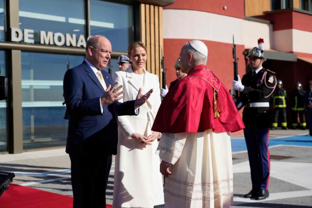 Prince Albert II of Monaco and Princess Charlene of Monaco welcome Pope Leo XIV on the tarmac of Monaco Heliport in Monte Carlo, Monaco, on March 28, 2026. Pope Leo XIV heads to the Mediterranean principality of Monaco on the French Riviera that is the pontiff's surprise pick for the first western European trip of his papacy. The US-born pope, a former missionary critical of the wealthy elite, will helicopter in for a day in the world's second-smallest state, best known for its casinos, luxury yachts and Michelin-starred dining. (Photo by Gregorio Borgia / POOL / AFP)