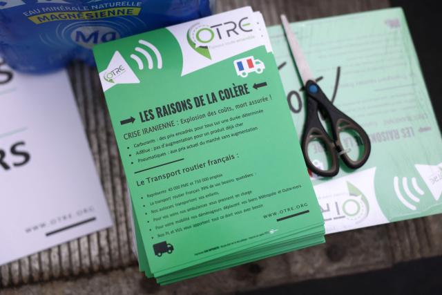This photograph shows a leaflet with the claims of carriers as French truck drivers block the A7 motorway, south of Lyon, to protest against rising fuel prices, in Chasse-sur-Rhône, central eastern France, on March 28, 2026. (Photo by Alex MARTIN / AFP)