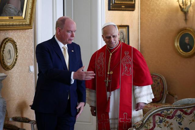 Pope Leo XIV and Prince Albert II of Monaco arrive for a private audience in the Prince's Palace of Monaco in Monte Carlo, Monaco, on March 28, 2026. Pope Leo XIV heads to the Mediterranean principality of Monaco on the French Riviera that is the pontiff's surprise pick for the first western European trip of his papacy. The US-born pope, a former missionary critical of the wealthy elite, will helicopter in for a day in the world's second-smallest state, best known for its casinos, luxury yachts and Michelin-starred dining. (Photo by Guglielmo Mangiapane / POOL / AFP)