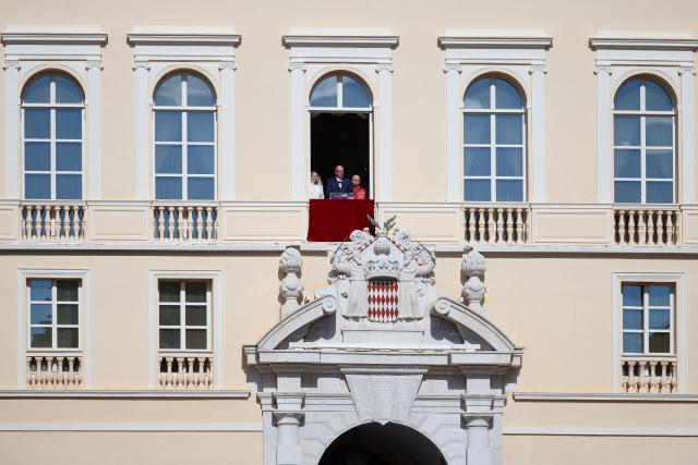 Prince's Albert II of Monaco gives a speech from the balcony next to Pope Leo XIV (R) and Princess Charlene of Monaco at the Prince's Palace of Monaco in Monte Carlo, Monaco, on March 28, 2026. Pope Leo XIV heads to the Mediterranean principality of Monaco on the French Riviera that is the pontiff's surprise pick for the first western European trip of his papacy. The US-born pope, a former missionary critical of the wealthy elite, will helicopter in for a day in the world's second-smallest state, best known for its casinos, luxury yachts and Michelin-starred dining. (Photo by Valery HACHE / AFP)