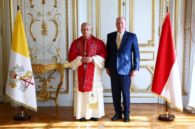 Pope Leo XIV poses with Prince Albert II of Monaco during a private audience in the Prince's Palace of Monaco in Monte Carlo, Monaco, on March 28, 2026. Pope Leo XIV heads to the Mediterranean principality of Monaco on the French Riviera that is the pontiff's surprise pick for the first western European trip of his papacy. The US-born pope, a former missionary critical of the wealthy elite, will helicopter in for a day in the world's second-smallest state, best known for its casinos, luxury yachts and Michelin-starred dining. (Photo by Guglielmo Mangiapane / POOL / AFP)