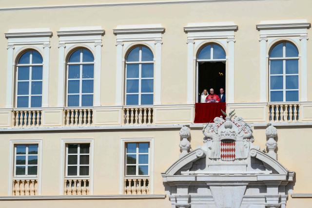 Pope Leo XIV  gives a speech from the balcony next to Prince's Albert II of Monaco (R) and Princess Charlene of Monaco at the Prince's Palace of Monaco in Monte Carlo, Monaco, on March 28, 2026. Pope Leo XIV heads to the Mediterranean principality of Monaco on the French Riviera that is the pontiff's surprise pick for the first western European trip of his papacy. The US-born pope, a former missionary critical of the wealthy elite, will helicopter in for a day in the world's second-smallest state, best known for its casinos, luxury yachts and Michelin-starred dining. (Photo by Marco BERTORELLO / AFP)