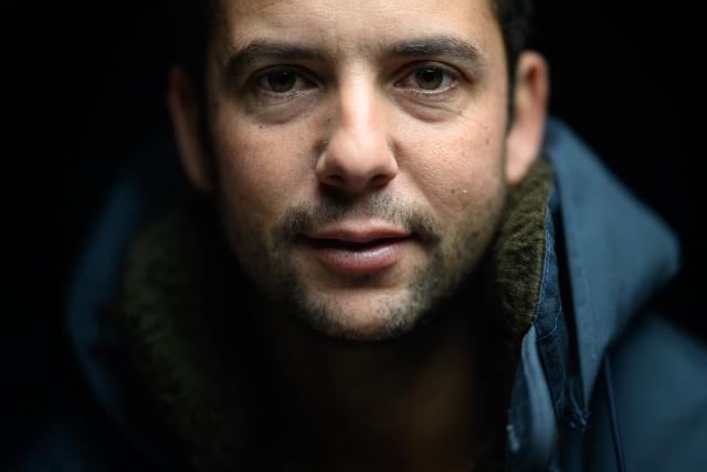 (FILES) French skipper Guirec Soudee poses aboard his Imoca 60 "Freelance.com" at the Vendee Globe village ahead of the 10th edition of the Vendee Globe around the world monohull solo sailing race, in Les Sables-d'Olonne, western France on November 7, 2024. On Mrach 28, 2026, French skipper Guirec Soudée smashed the record for sailing around the world in the opposite direction (from east to west, against prevailing winds and currents) aboard the MACSF maxi-trimaran in 94 days, 21 hours, and 58 minutes. (Photo by Loic VENANCE / AFP)