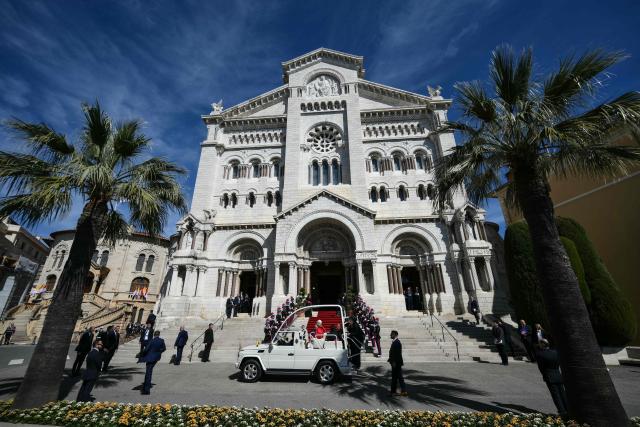 TOPSHOT - Pope Leo XIV arrives in his Papamobile to meet with members of the catholic community in the Cathedral of the Immaculate Conception in Monte Carlo, Monaco, on March 28, 2026. Pope Leo XIV heads to the Mediterranean principality of Monaco on the French Riviera that is the pontiff's surprise pick for the first western European trip of his papacy. The US-born pope, a former missionary critical of the wealthy elite, will helicopter in for a day in the world's second-smallest state, best known for its casinos, luxury yachts and Michelin-starred dining. (Photo by Marco BERTORELLO / AFP)