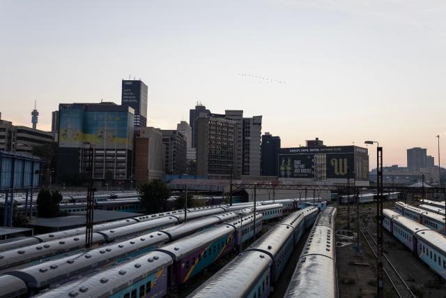 A general view of Shosholoza Meyl train carriages with the skyline of Braamfontein, Johannesburg, in the background on March 28, 2026. (Photo by Wikus de Wet / AFP)