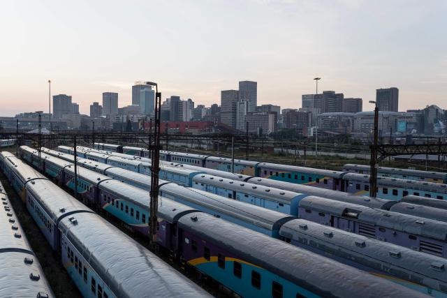 A general view of Shosholoza Meyl train carriages with the skyline of Johannesburg in the background on March 28, 2026. (Photo by Wikus de Wet / AFP)