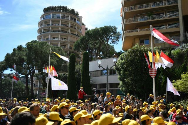 Youth and catechumens listen to Pope Leo XIV in front of the Church of Sainte-Devote in Monte Carlo, Monaco, on March 28, 2026. Pope Leo XIV heads to the Mediterranean principality of Monaco on the French Riviera that is the pontiff's surprise pick for the first western European trip of his papacy. The US-born pope, a former missionary critical of the wealthy elite, will helicopter in for a day in the world's second-smallest state, best known for its casinos, luxury yachts and Michelin-starred dining. (Photo by Marco BERTORELLO / AFP)