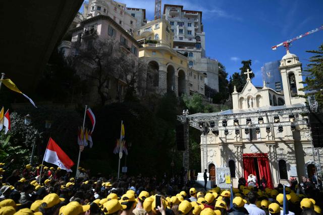 Pope Leo XIV meets with youth and catechumens in front of the Church of Sainte-Devote in Monte Carlo, Monaco, on March 28, 2026. Pope Leo XIV heads to the Mediterranean principality of Monaco on the French Riviera that is the pontiff's surprise pick for the first western European trip of his papacy. The US-born pope, a former missionary critical of the wealthy elite, will helicopter in for a day in the world's second-smallest state, best known for its casinos, luxury yachts and Michelin-starred dining. (Photo by Marco BERTORELLO / AFP)