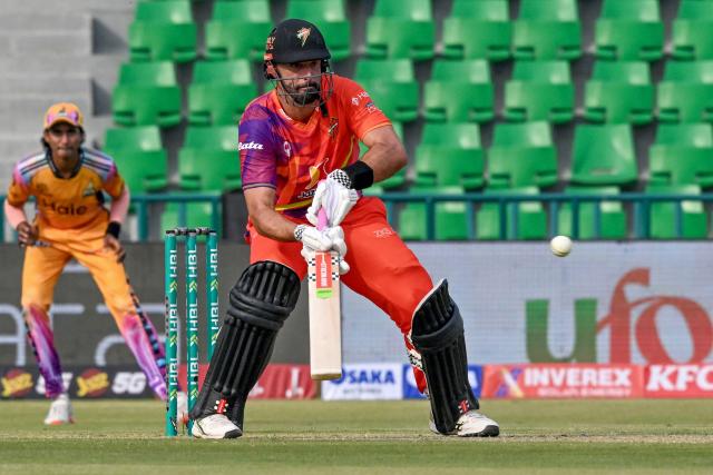 Rawalpindiz's New Zealand cricket player Daryl Mitchell plays a shot during the Pakistan Super League (PSL) Twenty20 cricket match between Peshawar Zalmi and Rawalpindiz at the Gaddafi Cricket Stadium in Lahore on March 28, 2026. (Photo by Arif ALI / AFP)