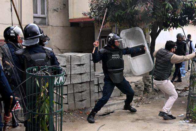 Police clash with Nepali former prime minister KP Sharma Oli's supporters as they protest against his arrest in Kathmandu on March 28, 2026. Nepal's former prime minister KP Sharma Oli and ex-home minister Ramesh Lekhak were arrested March 28 over their alleged involvement in a deadly crackdown on protestors in September, police said. (Photo by PRAKASH MATHEMA / AFP)