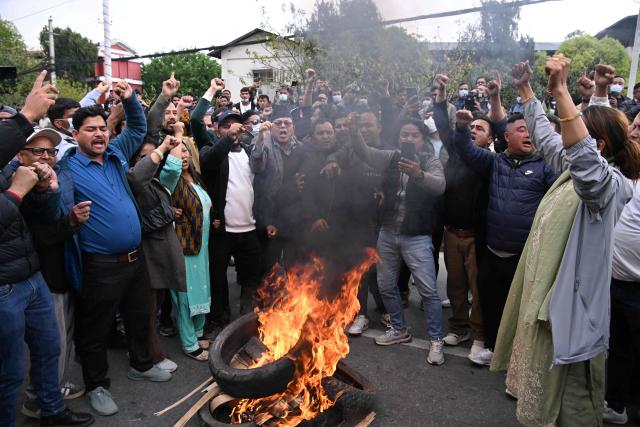 Supporters burn tyres to protest against the arrest of Nepali former prime minister KP Sharma Oli in Kathmandu on March 28, 2026. Nepal's former prime minister KP Sharma Oli and ex-home minister Ramesh Lekhak were arrested March 28 over their alleged involvement in a deadly crackdown on protestors in September, police said. (Photo by PRAKASH MATHEMA / AFP)