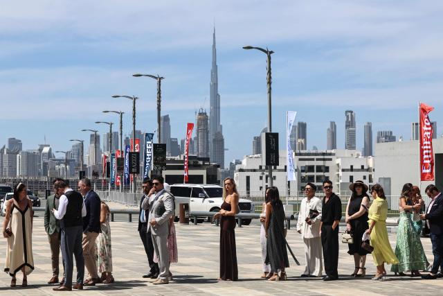 Guests line up to enter Meydan Racecourse to attend the Dubai World Cup horse race in Dubai on March 28, 2026. Since the United States and Israel began striking Iran on February 28, Tehran has launched waves of missiles and drones at Gulf states, with more than 2,000 attacks on the UAE alone. (Photo by Fadel SENNA / AFP)