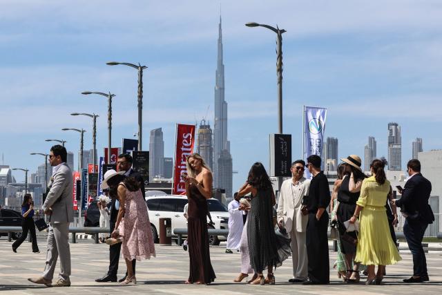 Guests line up to enter Meydan Racecourse to attend the Dubai World Cup horse race in Dubai on March 28, 2026. Since the United States and Israel began striking Iran on February 28, Tehran has launched waves of missiles and drones at Gulf states, with more than 2,000 attacks on the UAE alone. (Photo by Fadel SENNA / AFP)