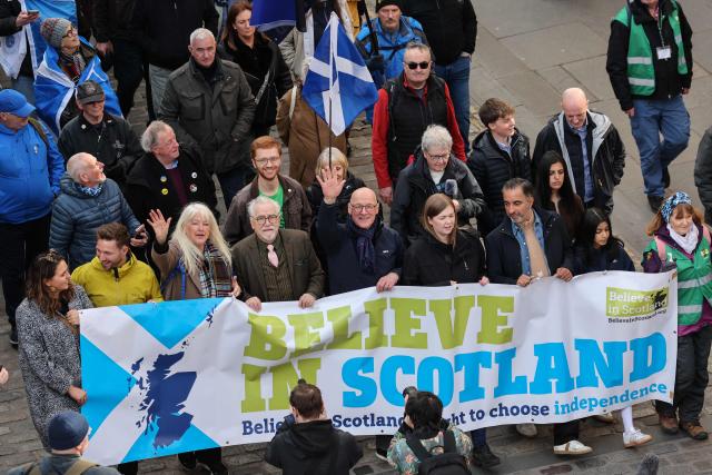 Participants hold a banner at the front of a march in support of Scottish independence in Edinburgh on March 28, 2026. (Photo by Robert Perry / AFP)