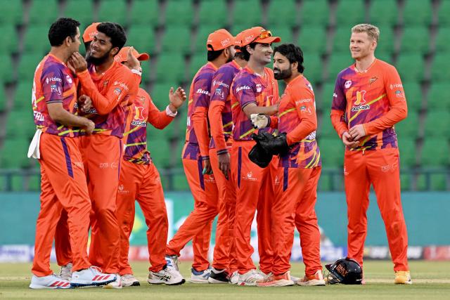 Rawalpindiz's Pakistani cricket player Asif Afridi (L) celebrates with teammates after taking the wicket of Peshawar Zalmi's Pakistani cricket captain Babar Azam during the Pakistan Super League (PSL) T20 match between Peshawar Zalmi and Rawalpindiz at the Gaddafi Cricket Stadium in Lahore on March 28, 2026. (Photo by Arif ALI / AFP)