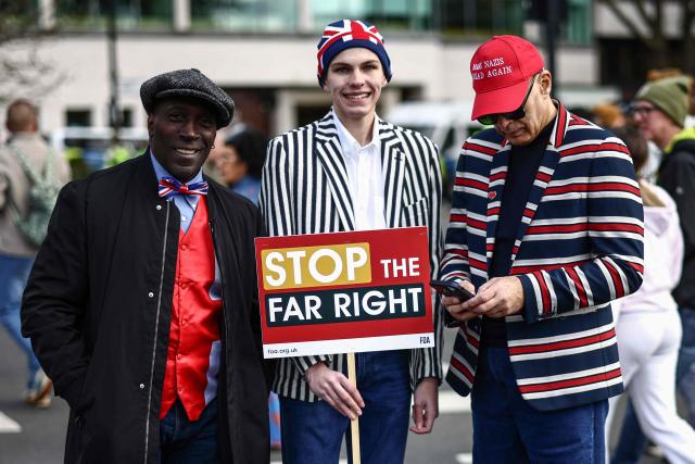 Protesters holding placards take part in a march against the far right, organised by the Together Alliance, in central London on March 28, 2026. (Photo by Henry NICHOLLS / AFP)