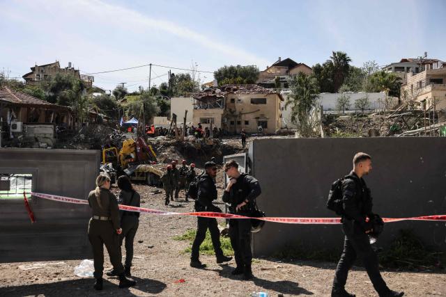 First responders and security forces work at the site of a projectile strike in Eshtaol, near Beit Shemesh in central Israel, on March 28, 2026. The Middle East was sparked by joint US-Israeli strikes on Iran that triggered a wave of retaliatory missile and drone attacks against Israel and several other countries in the region. (Photo by AHMAD GHARABLI / AFP) / 