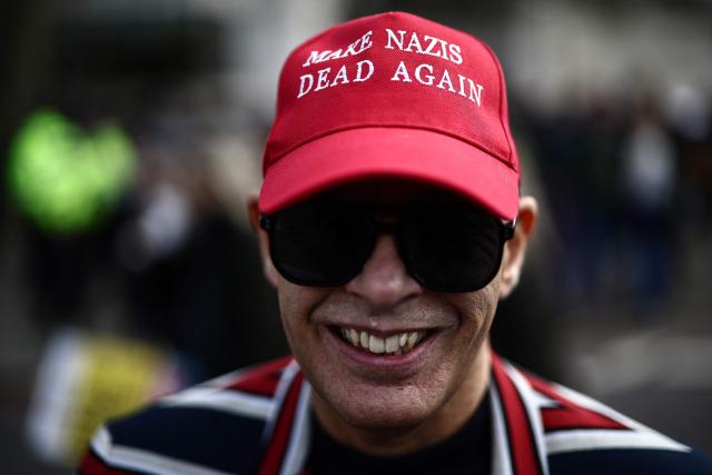 A protester wearing a cap reading "Make Nazis Dead Again" takes part in a march against the far right, organised by the Together Alliance, in central London on March 28, 2026. (Photo by Henry NICHOLLS / AFP)