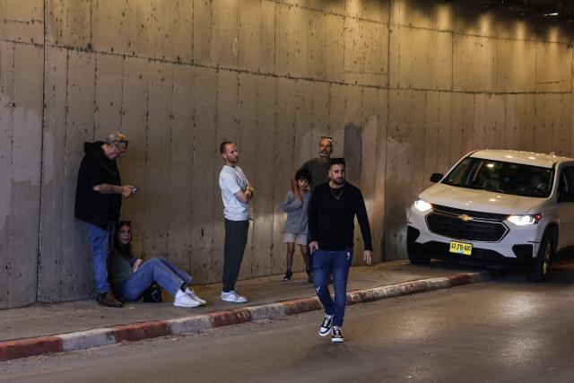 People take shelter inside a tunnel near Abu Ghosh as missile-warning sirens sound on March 28, 2026. The Middle East was sparked by joint US-Israeli strikes on Iran that triggered a wave of retaliatory missile and drone attacks against Israel and several other countries in the region. (Photo by AHMAD GHARABLI / AFP) / 