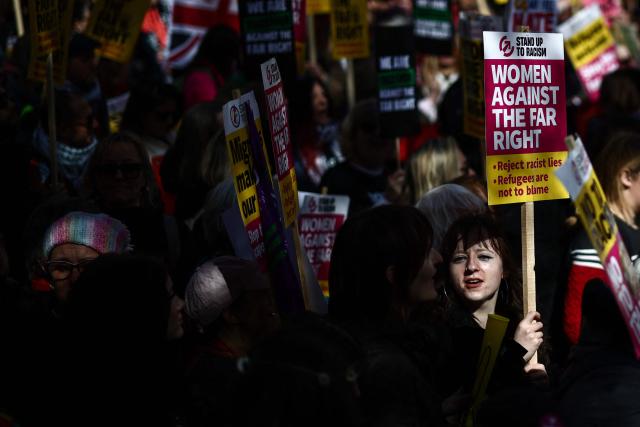 Protesters holding placards and waving flags take part in a march against the far right, organised by the Together Alliance, in central London on March 28, 2026. (Photo by Henry NICHOLLS / AFP)